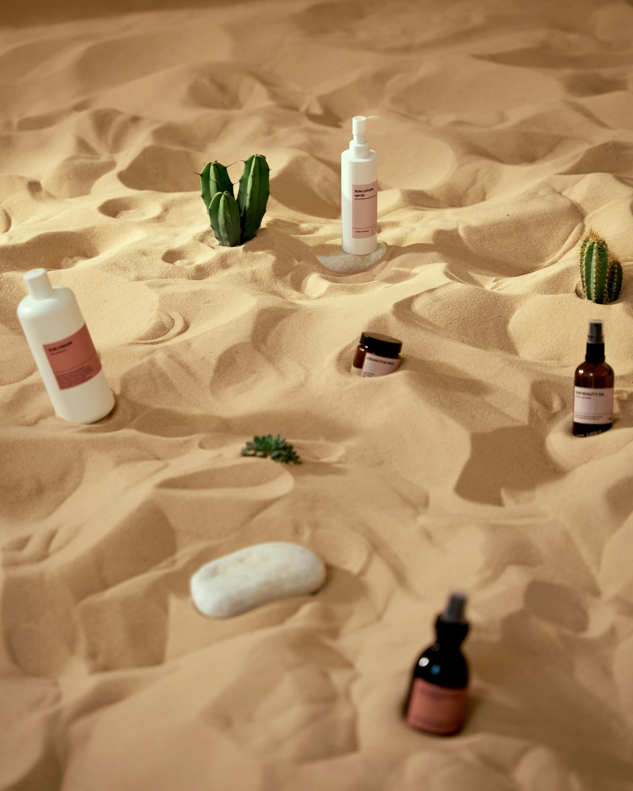 Home Creative skincare products presented on a desert sand backdrop for a unique visual experience.